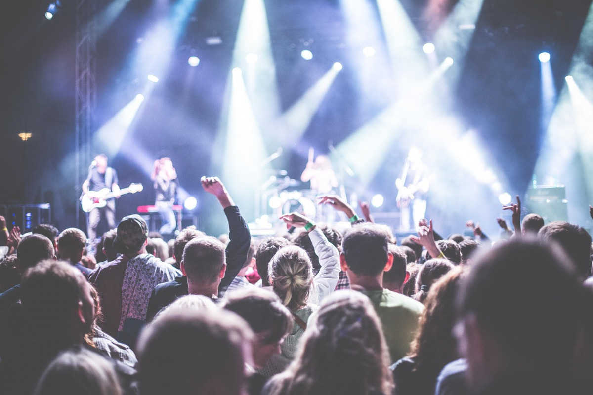 live band performing on stage with crowd